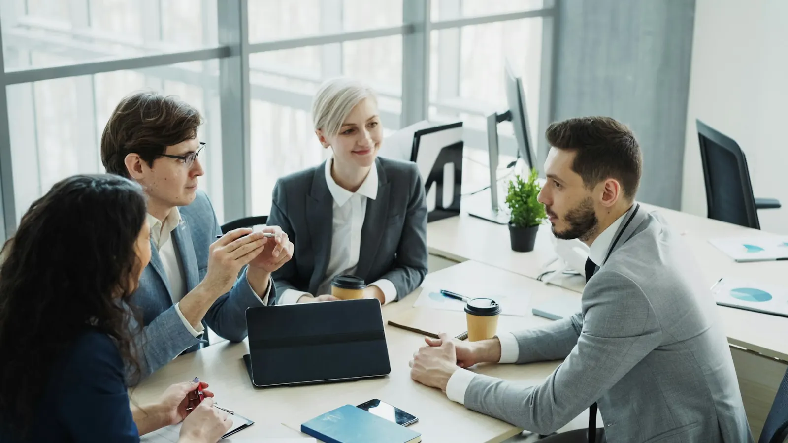 Business leaders discussing strategy around a modern conference table